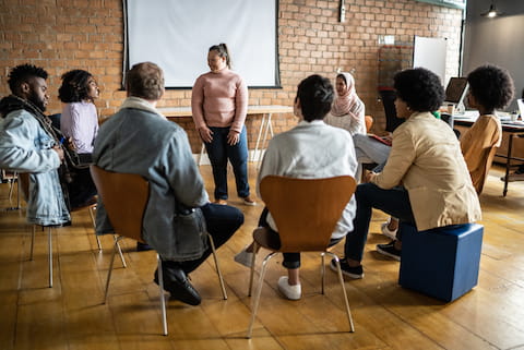 Young woman with special needs talking in a group