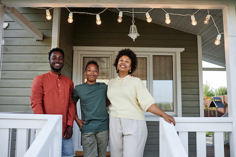 Family standing on front porch