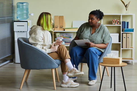 Social worker talking to teen girl